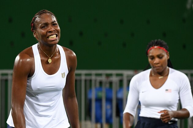 USA's Serena Williams (R) and USA's Venus Williams react after losing a point during their women's first round doubles tennis match against Czech Republic's Lucie Safarova and Czech Republic's Barbora Strycova at the Olympic Tennis Centre of the Rio 2016 Olympic Games in Rio de Janeiro on August 7, 2016. / AFP / Martin BERNETTI        (Photo credit should read MARTIN BERNETTI/AFP/Getty Images)