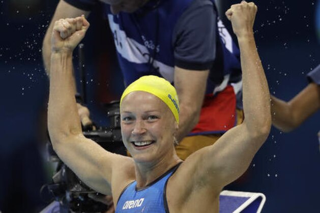 Sweden's gold medal winner Sarah Sjostrom celebrates after setting a new world record in the women's 100-meter butterfly final during the swimming competitions at the 2016 Summer Olympics, Sunday, Aug. 7, 2016, in Rio de Janeiro, Brazil. (AP Photo/David J. Phillip )