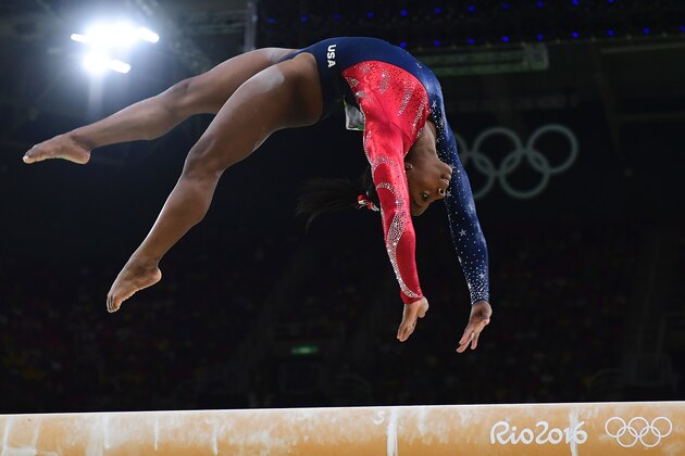 TOPSHOT - US gymnast Simone Biles competes in the qualifying for the women's Beam event of the Artistic Gymnastics at the Olympic Arena during the Rio 2016 Olympic Games in Rio de Janeiro on August 7, 2016. / AFP / Emmanuel DUNAND        (Photo credit should read EMMANUEL DUNAND/AFP/Getty Images)