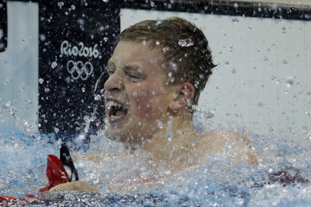Britain's Adam Peaty celebrates winning the gold medal in the men's 100-meter breaststroke setting a new world record during the swimming competitions at the 2016 Summer Olympics, Sunday, Aug. 7, 2016, in Rio de Janeiro, Brazil. (AP Photo/Matt Slocum)
