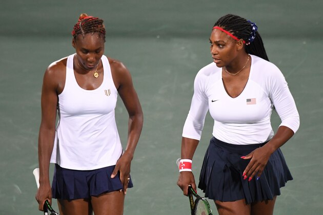 USA's Serena Williams (R) speaks to USA's Venus Williams during their women's first round doubles tennis match against Czech Republic's Lucie Safarova and Czech Republic's Barbora Strycova at the Olympic Tennis Centre of the Rio 2016 Olympic Games in Rio de Janeiro on August 7, 2016. / AFP / Martin BERNETTI        (Photo credit should read MARTIN BERNETTI/AFP/Getty Images)