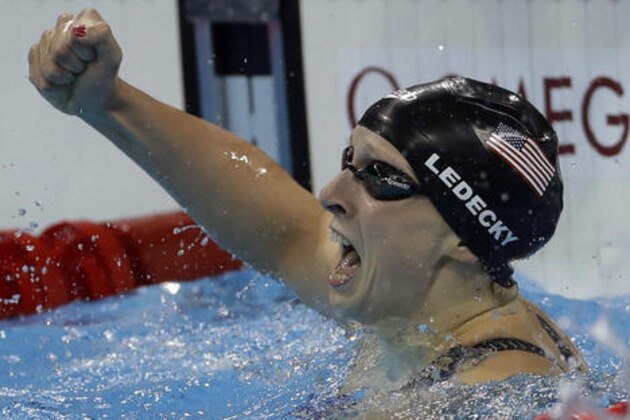 United States' Katie Ledecky celebrates winning the gold medal in the women's 400-meter freestyle setting a new world record during the swimming competitions at the 2016 Summer Olympics, Sunday, Aug. 7, 2016, in Rio de Janeiro, Brazil. (AP Photo/Matt Slocum)