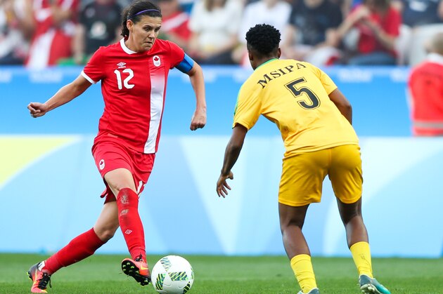 SAO PAULO, BRAZIL - AUGUST 06: Christine Sinclair (L)  of Canada and Emmaculate Msipa of Zimbabwe in action during  the match between Canada and Zimbabwe womens football for the summer olympics at Arena Corinthians on August 6, 2016 in Sao Paulo, Brazil. (Photo by Alexandre Schneider/Getty Images)