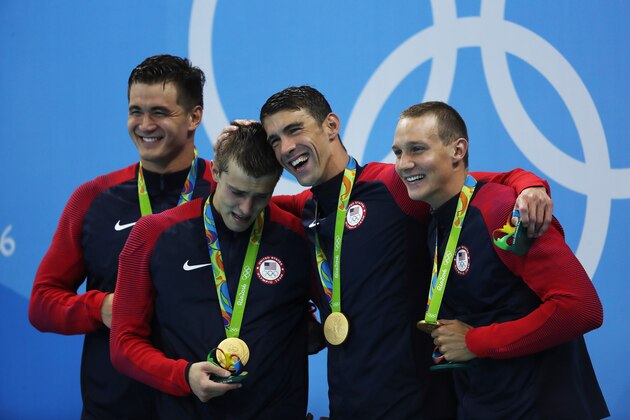 RIO DE JANEIRO, BRAZIL - AUGUST 07:  Gold medalists Nathan Adrian, Ryan Held, Michael Phelps and Caeleb Dressell of the United States pose on the podium during Day 2 of the Rio 2016 Olympic Games at Olympic Aquatics Stadium on August 7, 2016 in Rio de Janeiro, Brazil. (Photo by Ian MacNicol/Getty Images)
