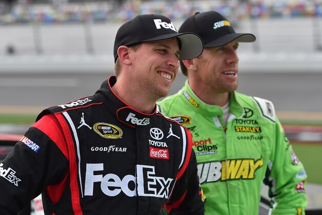 Jul 1, 2016; Daytona Beach, FL, USA; NASCAR Sprint Cup Series driver Denny Hamlin (L) and Carl Edwards (R) look on during qualifying for the Coke Zero 400 powered by Coca-Cola at Daytona International Speedway. Mandatory Credit: Jasen Vinlove-USA TODAY Sports