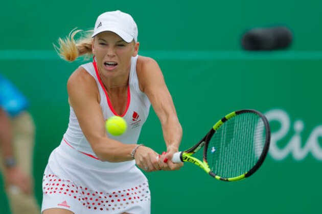 Caroline Wozniacki of Denmark returns a ball to Lucie Hradecka of the Czech Republic in the women's tennis competition at the 2016 Summer Olympics in Rio de Janeiro, Brazil, Sunday, Aug. 7, 2016. (AP Photo/Vadim Ghirda)