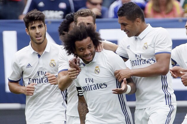 ANN ARBOR, MI - JULY 30:  Marcelo Vieira Da Silva #12 of Real Madrid is surrounded by teammates after scoring against Chelsea during the first half at Michigan Stadium on July 30, 2016 in Ann Arbor, Michigan. (Photo by Duane Burleson/Getty Images)