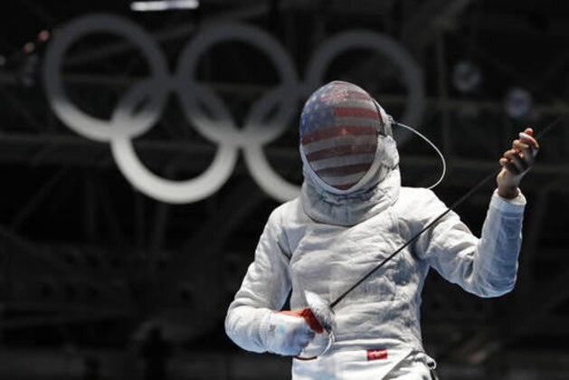 CORRECTS FIRST NAME TO IBTIHAJ FROM UBRIHAJ - Ibtihaj Muhammad, from United States, competes with Olena Kravatska from Ukraine, during the women's saber individual fencing event at the 2016 Summer Olympics in Rio de Janeiro, Brazil, Monday, Aug. 8, 2016. (AP Photo/Vincent Thian)