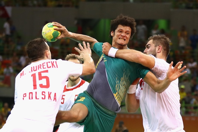 RIO DE JANEIRO, BRAZIL - AUGUST 07: Thiago dos Santos of Brazil is held back  during the Mens Preliminary Group B match between Poland and Brazil at the Future Arena on Day 2 of the Rio 2016 Olympic Games at the Future Arena on August 7, 2016 in Rio de Janeiro, Brazil.  (Photo by Phil Walter/Getty Images)