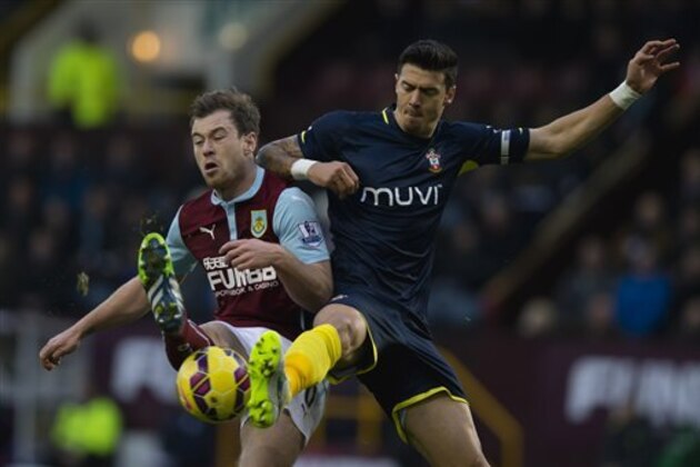 Burnley's Ashley Barnes, left, fights for the ball against Southampton's Jose Fonte during the English Premier League soccer match between Burnley and Southampton at Turf Moor Stadium, Burnley, England, Saturday, Dec. 13, 2014. (AP Photo/Jon Super)