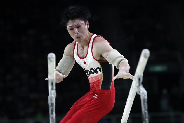 Japan's Kohei Uchimura competes in the parallel bars of the men's team final of the Artistic Gymnastics at the Olympic Arena during the Rio 2016 Olympic Games in Rio de Janeiro on August 8, 2016. / AFP / Thomas COEX        (Photo credit should read THOMAS COEX/AFP/Getty Images)