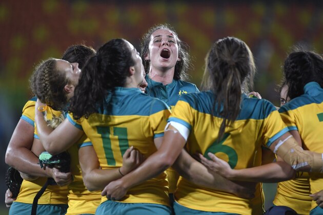 Australia's players celebrate victory in the womens rugby sevens gold medal match between New Zealand and Australia during the Rio 2016 Olympic Games at Deodoro Stadium in Rio de Janeiro on August 8, 2016. / AFP / John MACDOUGALL        (Photo credit should read JOHN MACDOUGALL/AFP/Getty Images)