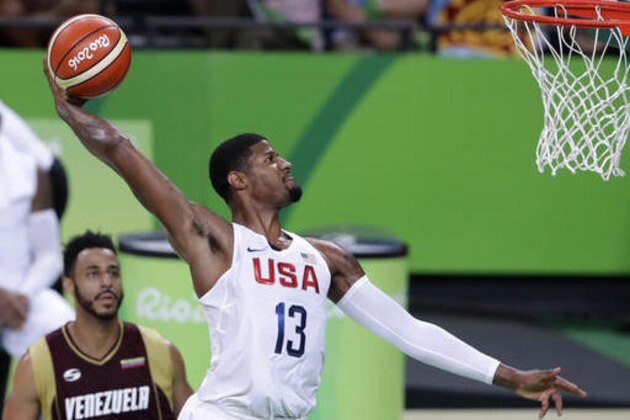 United States' Paul George (13) dunks the ball over Venezuela's Dwight Lewis, left, during a basketball game at the 2016 Summer Olympics in Rio de Janeiro, Brazil, Monday, Aug. 8, 2016. (AP Photo/Charlie Neibergall)
