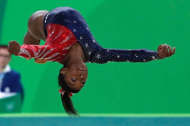 US gymnast Simone Biles competes in the qualifying for the women's Floor event of the Artistic Gymnastics at the Olympic Arena during the Rio 2016 Olympic Games in Rio de Janeiro on August 7, 2016. / AFP / Thomas COEX        (Photo credit should read THOMAS COEX/AFP/Getty Images)