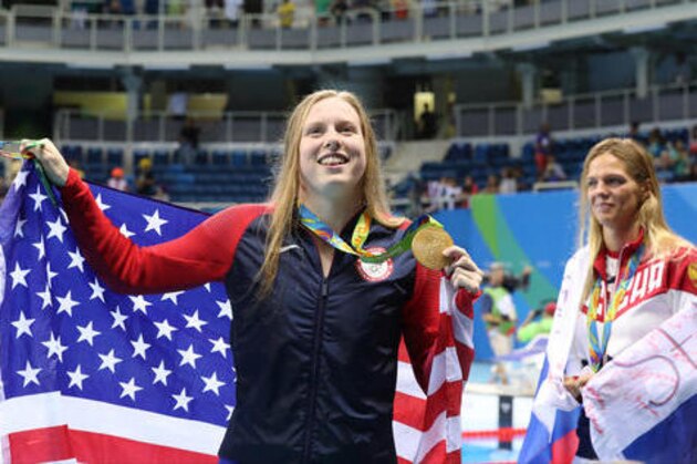 Winner United States' Lilly King and second placed Russia's Yulia Efimova, right, celebrate with their medals after the women's 100-meter breaststroke during the swimming competitions at the 2016 Summer Olympics, Tuesday, Aug. 9, 2016, in Rio de Janeiro, Brazil. (AP Photo/Lee Jin-man)