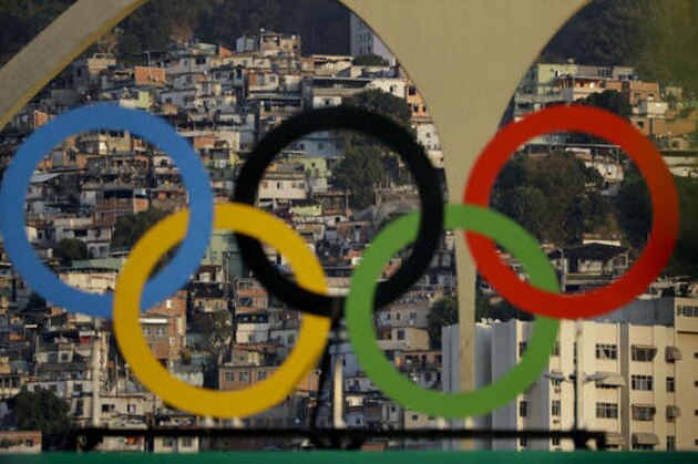 A slum is seen through the Olympic rings during the men's team archery competition at the Sambadrome venue during the 2016 Summer Olympics in Rio de Janeiro, Brazil, Saturday, Aug. 6, 2016.(AP Photo/Natacha Pisarenko)