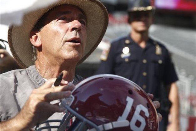 Alabama coach Nick Saban signs autographs  during the college football fan day, Sunday, Aug. 7, 2016, at Bryant-Denny Stadium in Tuscaloosa, Ala. (AP Photo/Brynn Anderson)