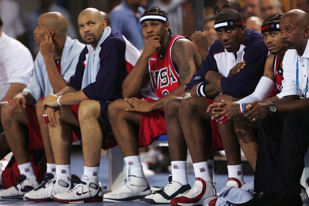ATHENS - AUGUST 15:  (L to R) Richard Jefferson, Carlos Boozer, Carmelo Anthony, Amare Stoudemire and Allen Iverson of the United States sit stoically on the bench in the men's basketball preliminary game on August 15, 2004 during the Athens 2004 Summer Olympic Games at the Indoor Arena of the Helliniko Olympic Complex in Athens, Greece. Puerto Rico won 92-73. (Photo by Jamie Squire/Getty Images)