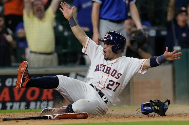 HOUSTON, TX - AUGUST 01:  Jose Altuve #27 of the Houston Astros slides to score the wining run in the fourteenth inning at Minute Maid Park on August 1, 2016 in Houston, Texas.  (Photo by Bob Levey/Getty Images)