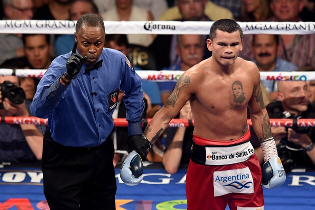 LAS VEGAS, NV - SEPTEMBER 13:  Referee Kenny Bayless deducts a point from Marcos Maidana for pushing down Floyd Mayweather Jr. during their WBC/WBA welterweight title fight at the MGM Grand Garden Arena on September 13, 2014 in Las Vegas, Nevada.  (Photo by Ethan Miller/Getty Images)