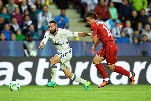 Real Madrid's Spanish defender Dani Carvajal (L) and Sevilla's Ukrainian midfielder Yevhen Konoplyanka vie for the ball during the UEFA Super Cup final football match between Real Madrid CF and Sevilla FC on August 9, 2016 at the Lerkendal Stadium in Trondheim. / AFP / JONATHAN NACKSTRAND        (Photo credit should read JONATHAN NACKSTRAND/AFP/Getty Images)