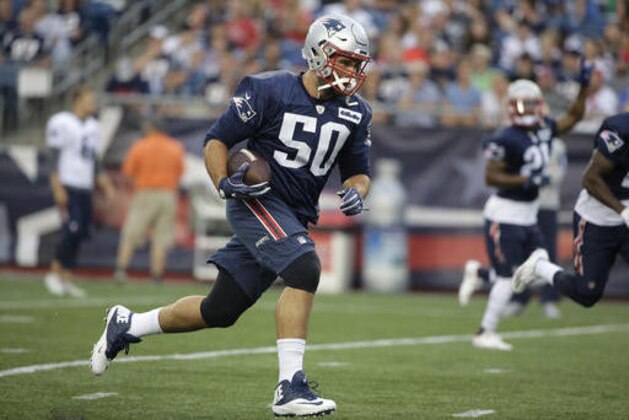 In this Monday, Aug. 1, 2016, photo New England Patriots defensive end Rob Ninkovich (50) runs with the ball during NFL football training camp in Foxborough, Mass. The Patriots defense, led by veterans like Ninkovich and linebacker Dont'a Hightower, among others, has been able to maintain lots of continuity from a defense that was ranked among the top teams in the AFC in 2015. (AP Photo/Steven Senne)