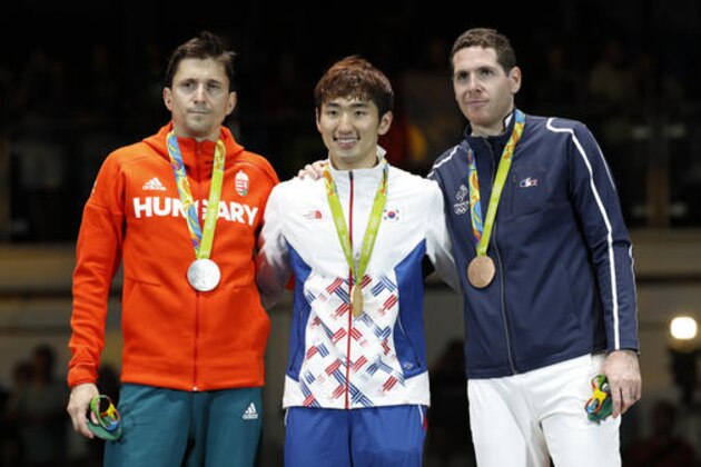 From left to right, Geza Imre from Hungary, Park Sang-young of South Korea, Gauthier Grumier of France poses photographers after the awards ceremony in the men's epee individual fencing event at the 2016 Summer Olympics in Rio de Janeiro, Brazil, Tuesday, Aug. 9, 2016. (AP Photo/Vincent Thian)