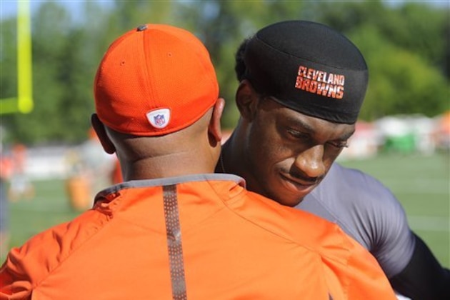 Cleveland Browns quarterback Robert Griffin III hugs head coach Hue Jackson after practice at the NFL football team's training camp Monday, Aug. 1, 2016, in Berea, Ohio. (AP Photo/David Richard)