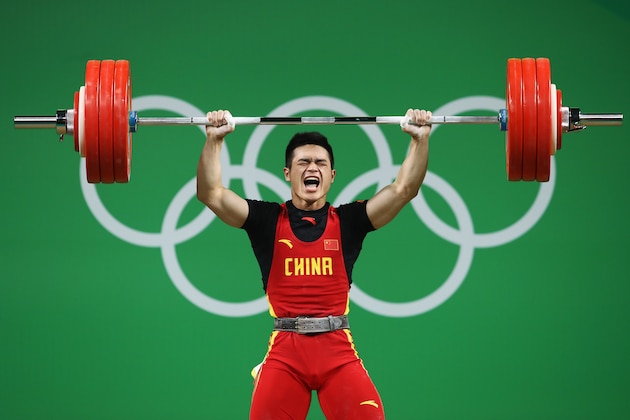 RIO DE JANEIRO, BRAZIL - AUGUST 09:  Zhiyong Shi of China competes during the Men's 69kg Group A Weightlifting contest on Day 4 of the Rio 2016 Olympic Games at the Riocentro - Pavilion 2 on August 9, 2016 in Rio de Janeiro, Brazil.  (Photo by Julian Finney/Getty Images)