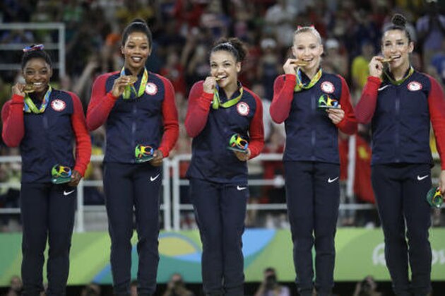 U.S. gymnasts, left to right, Simone Biles, Gabrielle Douglas, Lauren Hernandez, Madison Kocian and Aly Raisman hold their gold medals during the medal ceremony for the artistic gymnastics women's team at the 2016 Summer Olympics in Rio de Janeiro, Brazil, Tuesday, Aug. 9, 2016. (AP Photo/Julio Cortez)