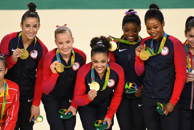 Aug 9, 2016; Rio de Janeiro, Brazil; Team USA celebrates winning gold medals during the women's team finals in the Rio 2016 Summer Olympic Games at Rio Olympic Arena. Mandatory Credit: Robert Deutsch-USA TODAY Sports