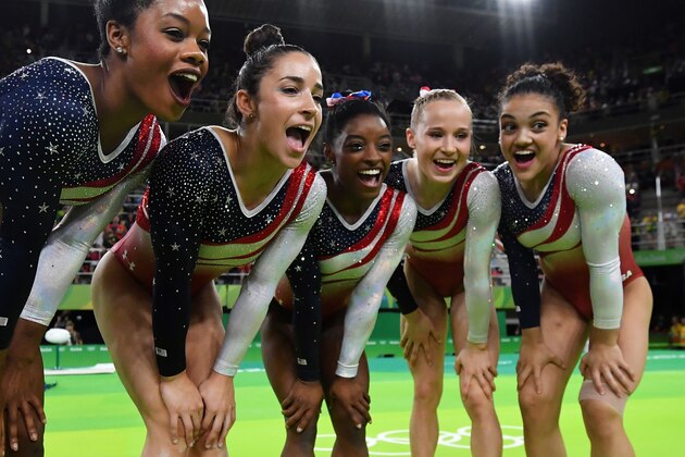 US gymnasts celebrate after the women's team final Artistic Gymnastics at the Olympic Arena during the Rio 2016 Olympic Games in Rio de Janeiro on August 9, 2016. / AFP / Ben STANSALL        (Photo credit should read BEN STANSALL/AFP/Getty Images)
