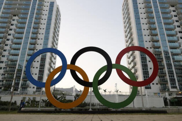 FILE - In this July 23, 2016 file photo, a representation of the Olympic rings are displayed in the Olympic Village in Rio de Janeiro, Brazil. Athletes increasingly are using apps like Tinder as they look to have fun and escape the pressures of competition inside the Olympic Village. (AP Photo/Leo Correa, File)