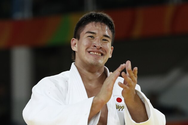 Japan's Mashu Baker (white) celebrates after defeating Georgia's Varlam Liparteliani during their men's -90kg judo contest gold medal match of the Rio 2016 Olympic Games in Rio de Janeiro on August 10, 2016. / AFP / Jack GUEZ        (Photo credit should read JACK GUEZ/AFP/Getty Images)