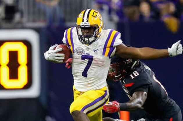 FILE - In this Dec. 29, 2015, file photo, LSU running back Leonard Fournette (7) rushes past Texas Tech defensive back Nigel Bethel, left, and linebacker Micah Awe (18) during the second half of the Texas Bowl NCAA football game, in Houston.  (AP Photo/Bob Levey, File)