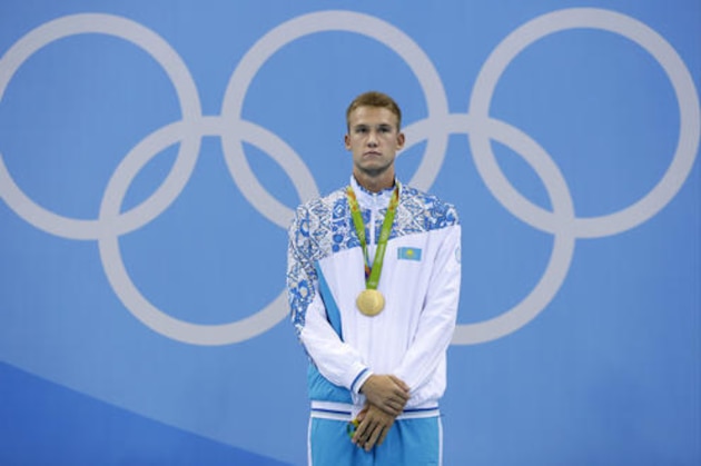 Kazakhstan's gold medal winner Dmitriy Balandin listens to the national anthem during the ceremony for the men's 200-meter breaststroke final during the swimming competitions at the 2016 Summer Olympics, Wednesday, Aug. 10, 2016, in Rio de Janeiro, Brazil. (AP Photo/Michael Sohn)