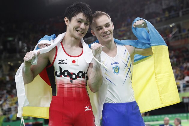 Gold medallise Japan's Kohei Uchimura (L) celebrates with silver medallist Ukraine's Oleg Verniaiev during the men's individual all-around final of the Artistic Gymnastics at the Olympic Arena during the Rio 2016 Olympic Games in Rio de Janeiro on August 10, 2016. / AFP / Thomas COEX        (Photo credit should read THOMAS COEX/AFP/Getty Images)
