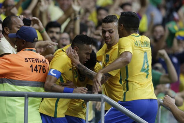 Brazil's Gabriel Barbosa, center, celebrates with teammates Brazil's Neymar, center left, and Brazil's Marquinhos, right after scoring his team's first goal during a group A match of the men' s Olympic football tournament between Brazil and Denmark in Salvador, Brazil, Wednesday Aug. 10, 2016.(AP Photo/Leo Correa)