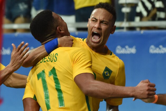 TOPSHOT - Gabriel Jesus (L) of Brazil celebrates with teammate Neymar his goal against Denmark during the Rio 2016 Olympic Games mens first round Group A football match Brazil vs Denmark, at the Arena Fonte Nova Stadium in Salvador, Brazil on August 10, 2016 / AFP / NELSON ALMEIDA        (Photo credit should read NELSON ALMEIDA/AFP/Getty Images)