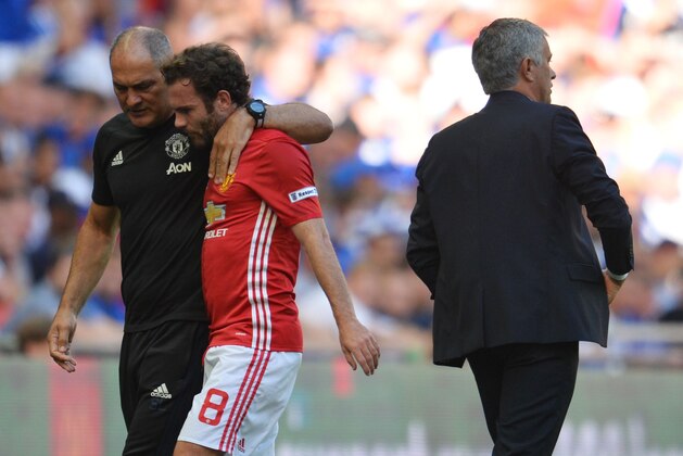 Manchester United's Spanish midfielder Juan Mata (C) talks with Manchester United's Portuguese first team coach Silvino Louro (L) after he is substituted late on during the FA Community Shield football match between Manchester United and Leicester City at Wembley Stadium in London on August 7, 2016.  / AFP / GLYN KIRK / NOT FOR MARKETING OR ADVERTISING USE / RESTRICTED TO EDITORIAL USE        (Photo credit should read GLYN KIRK/AFP/Getty Images)
