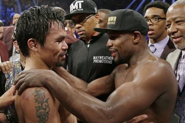 FILE - This May 2, 2015 file photo shows Manny Pacquiao, from the Philippines, left, and Floyd Mayweather Jr., embrace in the ring at the finish of their welterweight title fight in Las Vegas. Boxing fans across the country or at least their lawyers are calling the hyped-up fight between Pacquiao and Mayweather a fraud. Some 31 class action lawsuits had been filed through Friday alleging primarily the same thing: that Pacquiao's pre-existing shoulder injury should have been disclosed to fans ahead of time. (AP Photo/Isaac Brekken,File)