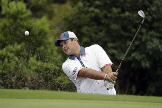 Patrick Reed, of the United States, hits from the bunker on the 13th hole during a practice round for men's golf event at the 2016 Summer Olympics in Rio de Janeiro, Brazil, Wednesday, Aug. 10, 2016. (AP Photo/Chris Carlson)