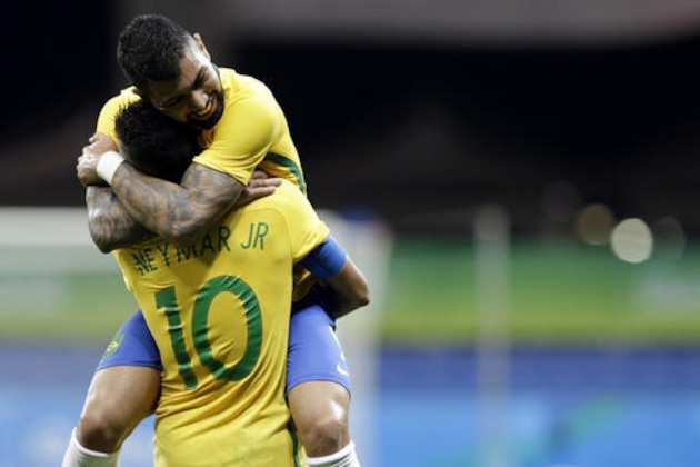 Brazil's Gabriel Barbosa celebrates with teammate Neymar after scoring his team's first goal during a group A match of the men' s Olympic football tournament between Brazil and Denmark in Salvador, Brazil, Wednesday Aug. 10, 2016.(AP Photo/Leo Correa)