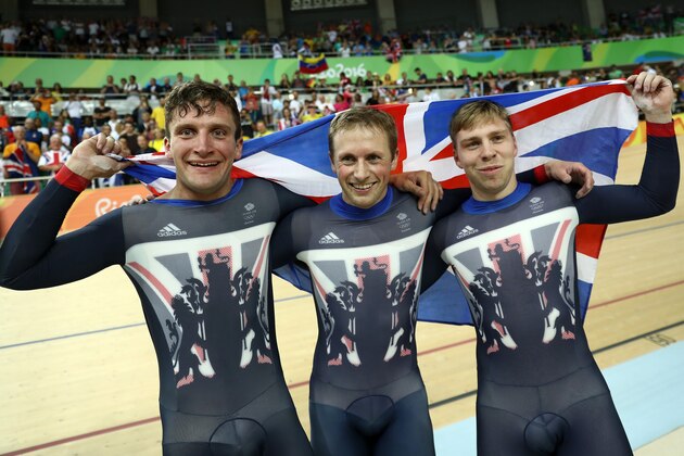 RIO DE JANEIRO, BRAZIL - AUGUST 11:  Callum Skinner, Jason Kenny and Philip Hindes of Great Britain celebrate after winning gold and getting an Olympic record in the Men's Team Sprint Track Cycling Finals
on Day 6 of the 2016 Rio Olympics at Rio Olympic Velodrome on August 11, 2016 in Rio de Janeiro, Brazil.  (Photo by Bryn Lennon/Getty Images)