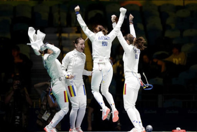 From left, Loredana Dinu, Ana Maria Popescu, Simona Gherman and Simona Pop of the Romania celebrate after defeating Russia in a women's team epee fencing semifinal at the 2016 Summer Olympics in Rio de Janeiro, Brazil, Thursday, Aug. 11, 2016. (AP Photo/Andrew Medichini)