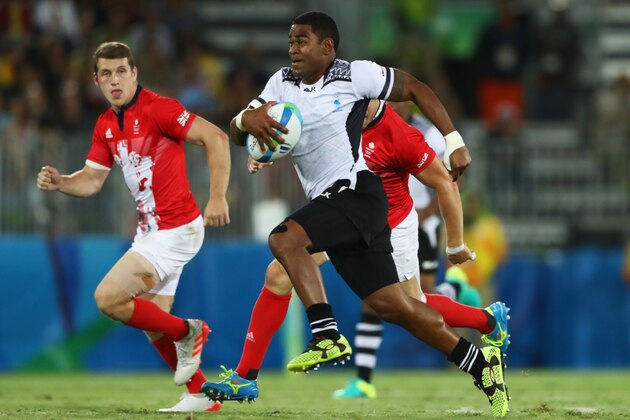 RIO DE JANEIRO, BRAZIL - AUGUST 11:  Vatemo Ravouvou of Fiji breaks through to score a try during the Men's Rugby Sevens Gold medal final match between Fiji and Great Britain on Day 6 of the Rio 2016 Olympics at Deodoro Stadium on August 11, 2016 in Rio de Janeiro, Brazil.  (Photo by David Rogers/Getty Images)