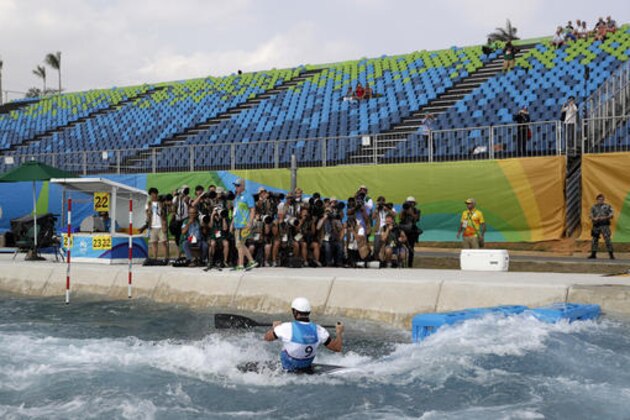 Empty seats are seen as Vitezslav Gebas, of the Czech Republic, competes during the canoe single C1 men's semifinal of the Canoe Slalom at the 2016 Summer Olympics in Rio de Janeiro, Brazil, Tuesday, Aug. 9, 2016. (AP Photo/Jae C. Hong)