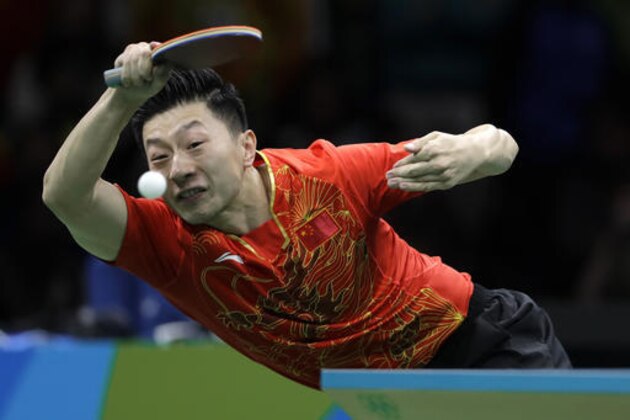 Ma Long, of China, returns a shot to Zhang Jike, of China, during the men's table tennis gold medal match at the 2016 Summer Olympics in Rio de Janeiro, Brazil, Thursday, Aug. 11, 2016. (AP Photo/Petros Giannakouris)