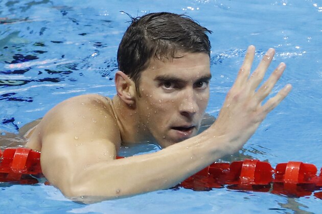 USA's Michael Phelps holds up four fingers for his fourth gold medal after he won the Men's 200m Individual Medley Final during the swimming event at the Rio 2016 Olympic Games at the Olympic Aquatics Stadium in Rio de Janeiro on August 11, 2016.   / AFP / Odd Andersen        (Photo credit should read ODD ANDERSEN/AFP/Getty Images)