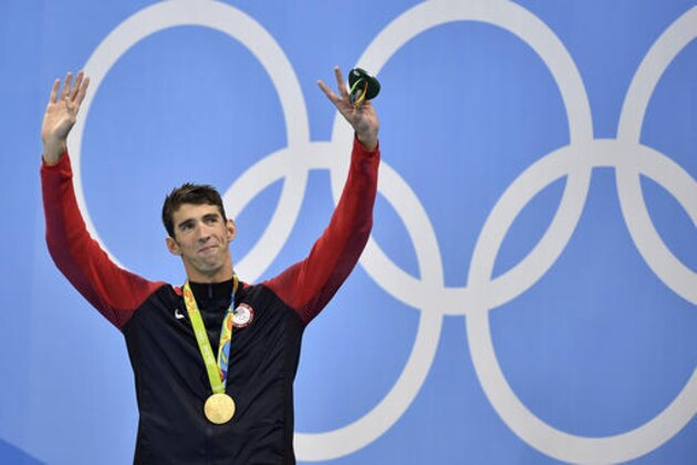 United States' Michael Phelps celebrates after he was awarded the gold medal during the medal ceremony for the men's 200-meter individual medley final during the swimming competitions at the 2016 Summer Olympics, Thursday, Aug. 11, 2016, in Rio de Janeiro, Brazil. (AP Photo/Martin Meissner)